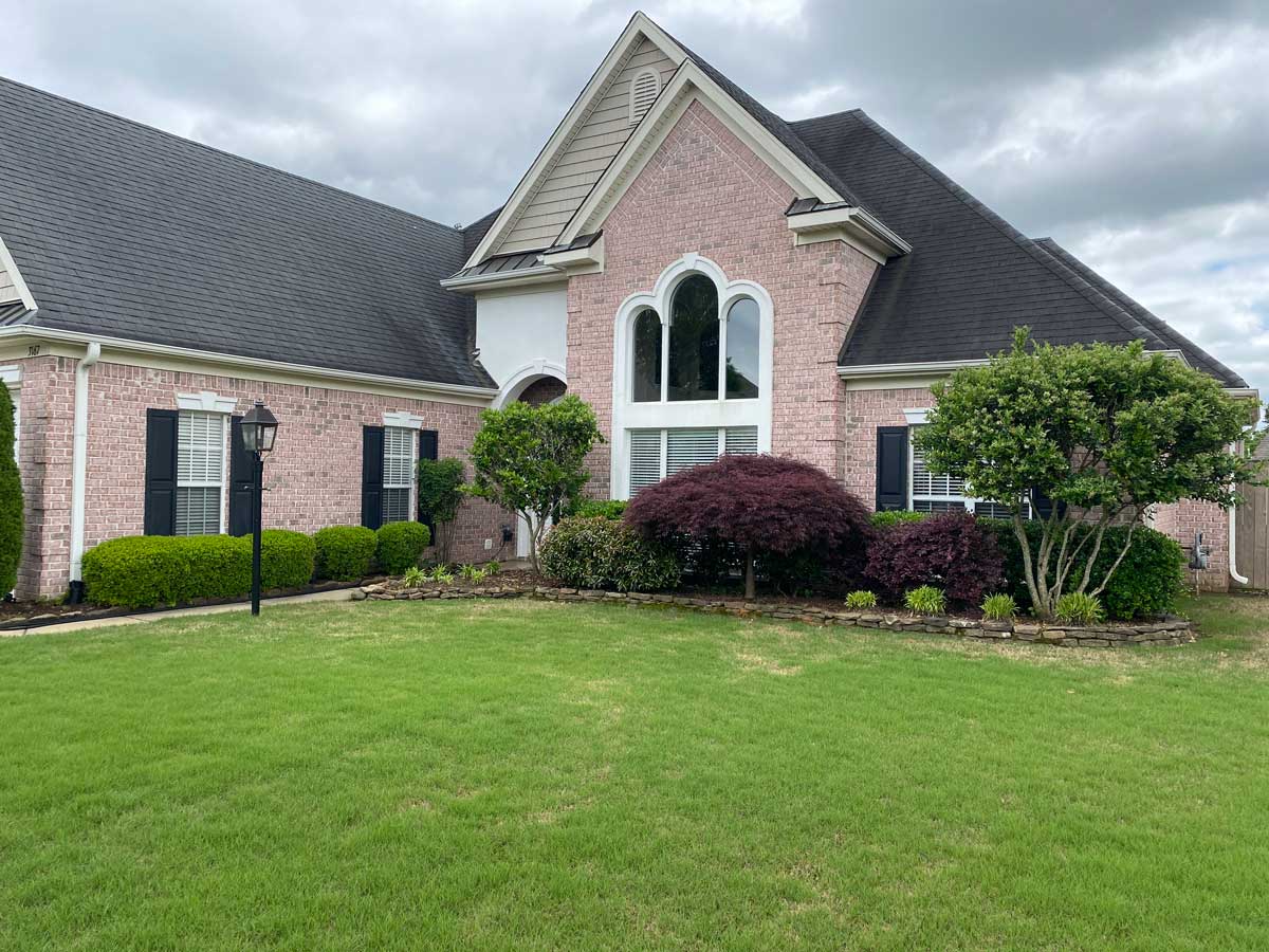 Large brick family home with new custom style windows installed