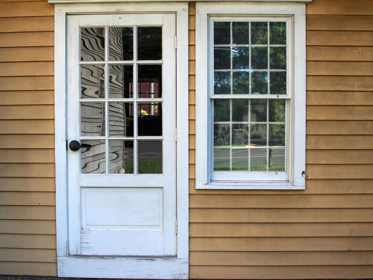 Old window and entry door that may need repair or replacement.