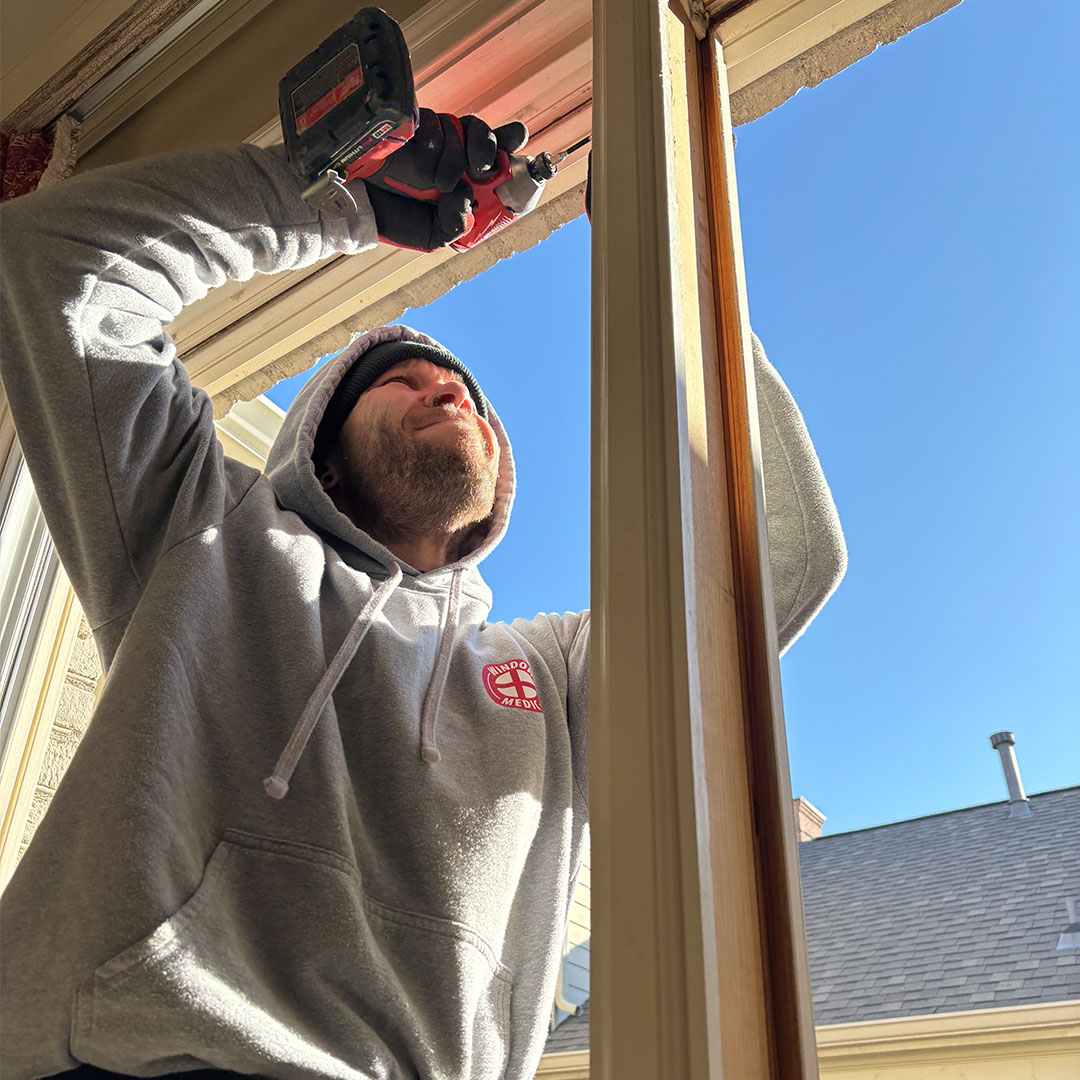 Window Medic technician installing a new window replacement.